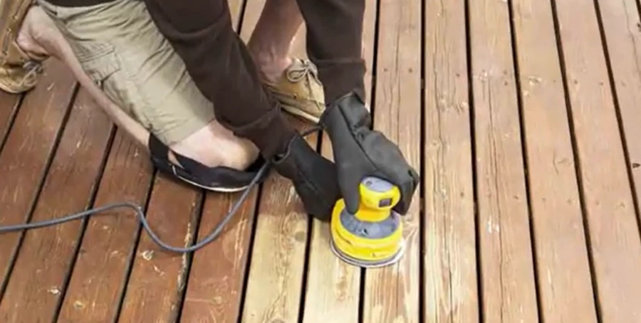 Sanding a weathered wood deck ahead of refinishing in Kettering, Ohio